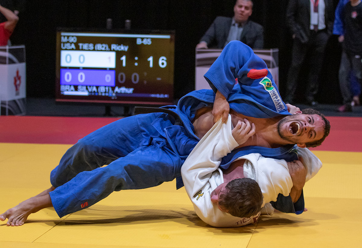 Two judoka with visual impairments grapple on the mat at the Baku 2019 Grand Prix