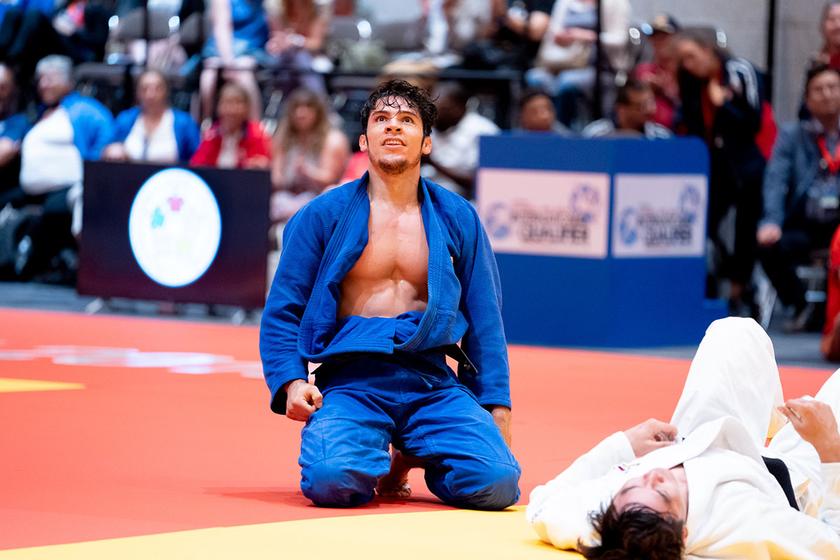 Eduardo Avila Sanchez of Mexico kneels on the mat and gazes at the sky