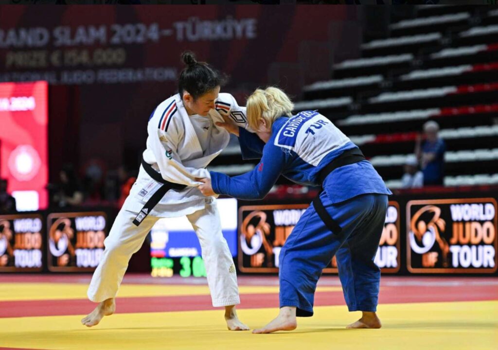 Turkiye's Eke Cahide grapples with an opponent whilst standing
